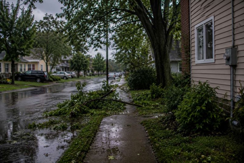 Storm damage near residential electrical equipment after severe weather.